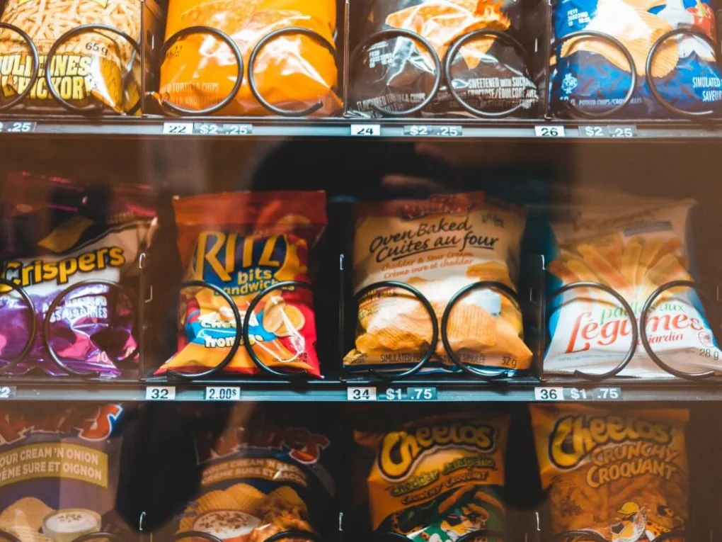 Where-Brevard-Comes-to-Play-30-1024×1024 Assorted snack bags in a vending machine, including chips and crackers.